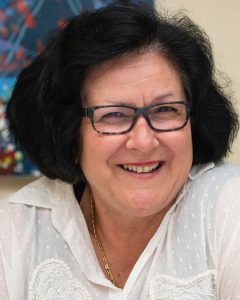 Melissa Del Borrello wearing square-shaped glasses and smiling